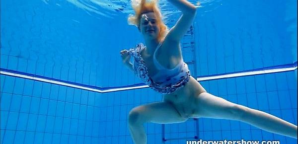  Cute Lucie is stripping underwater